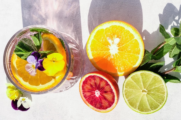 Cooling drink with mint and citruses on a white background oranges grapefruit lime