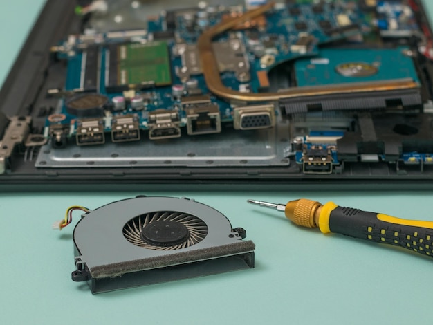 Cooling fan on the background of the disassembled laptop case