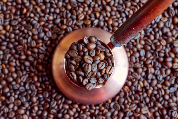 Copper Cezve filled with coffee beans.