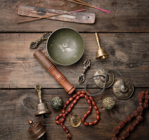 Copper singing bowl, prayer beads, prayer drum and other Tibetan religious objects for meditation and alternative medicine 