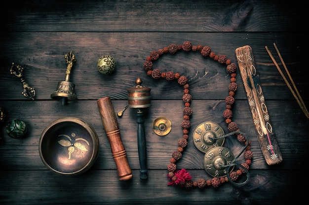 Copper singing bowl, prayer beads, prayer drum and other Tibetan religious objects for meditation 