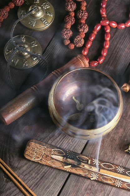 Copper singing bowl and a wooden stick 