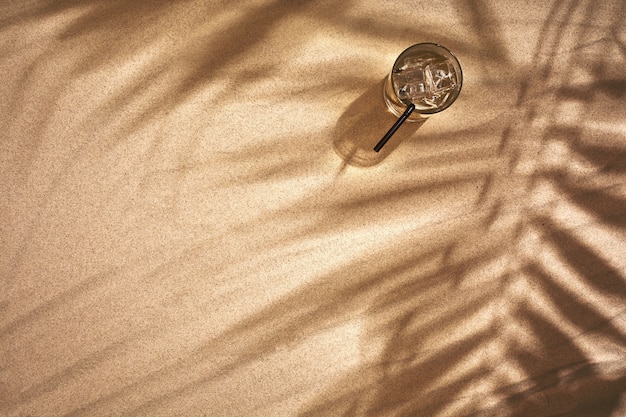 Copy space of shadow palm leaf on sand beach