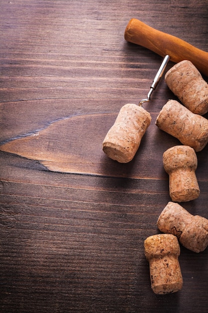 Copyspace background corks of champagne with corkscrew on vintage wooden board alcohol concept