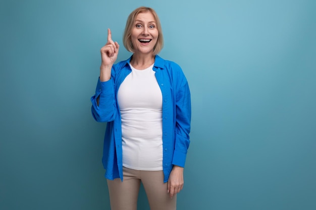 Coquettish blonde mature woman with bob haircut on studio background