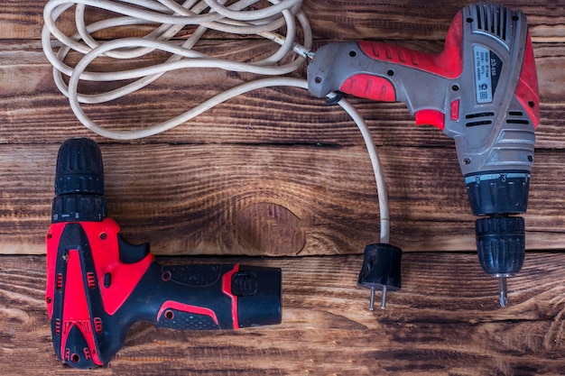 Cordless or driller on a wooden background