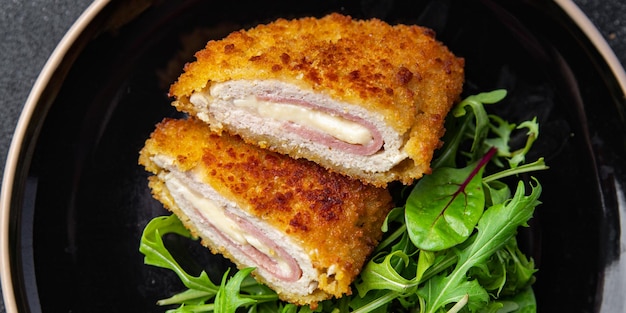 cordon bleu cutlet chicken meat, cheese, bacon meal snack on the table copy space food background