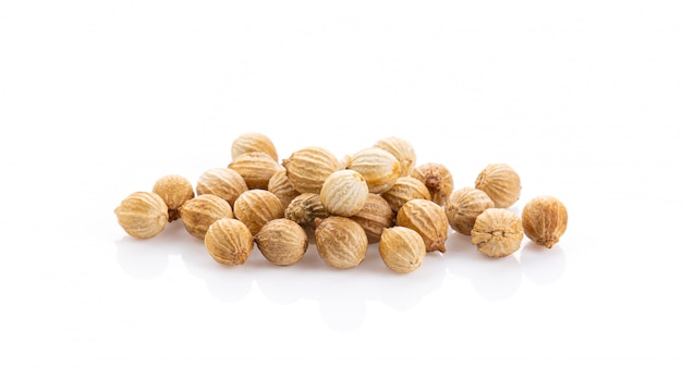 Coriander seeds on white wall