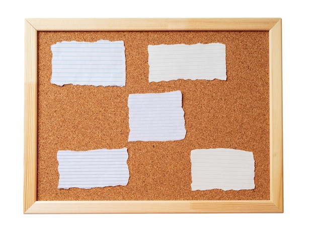 Cork note board with wooden frame with various blank torn note sheets isolated on white background