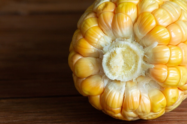 Corn cob on dark wooden rustic table