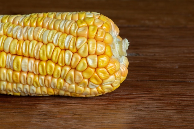 Corn cob on dark wooden rustic table