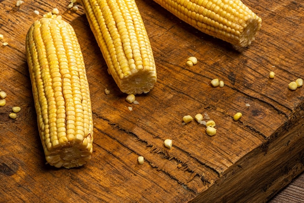 Corn on the cob on rustic wooden background