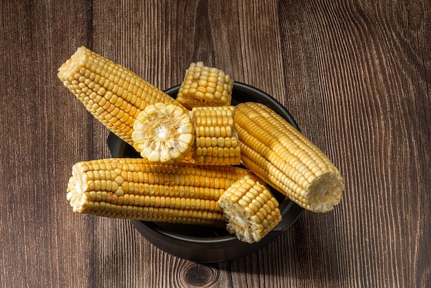 Corn on the cob on rustic wooden background