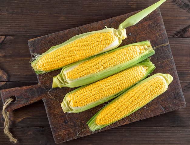 Corn cobs on an old brown kitchen board