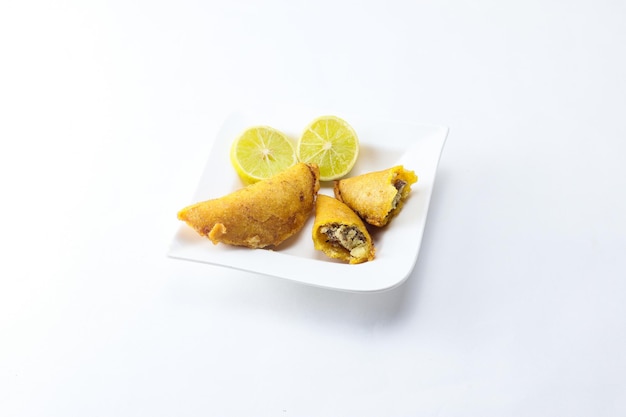 Corn empanada typical Colombian food with lemon and copy space