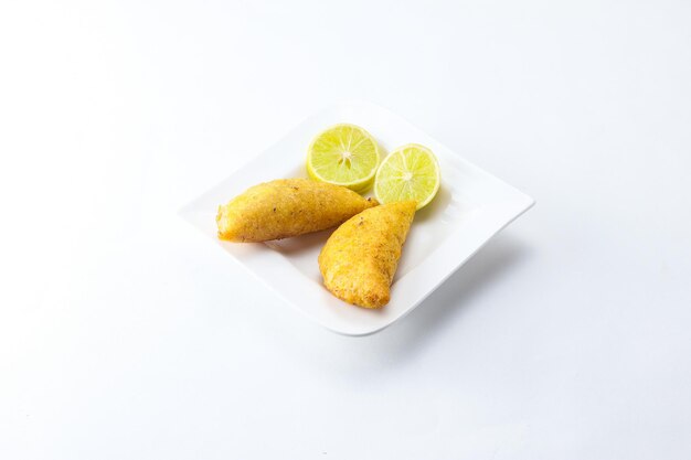 Corn empanada typical Colombian food with lemon