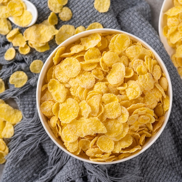 Corn flakes bowl sweets on gray cement background top view flat lay layout design fresh and healthy breakfast concept