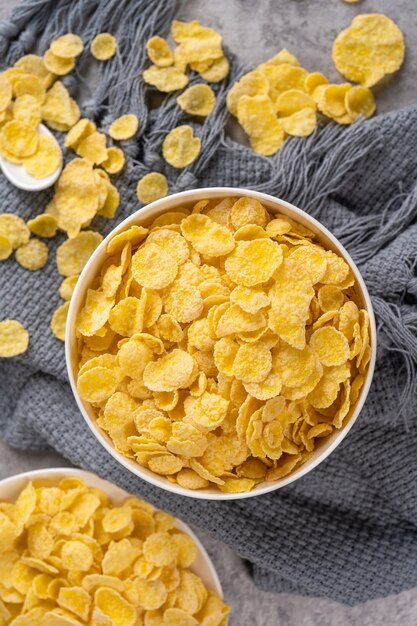 Corn flakes bowl sweets on gray cement background