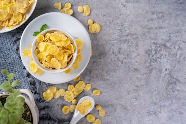 Corn flakes bowl sweets on gray cement table