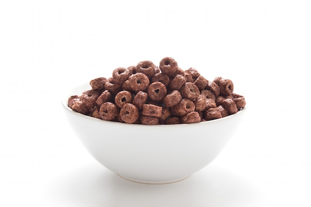 Corn flakes chocolate rings in a bowl isolated on white background.