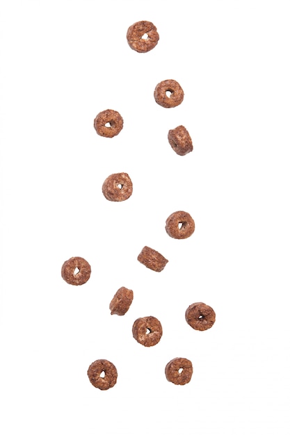 Corn flakes chocolate rings falling isolated on white background.