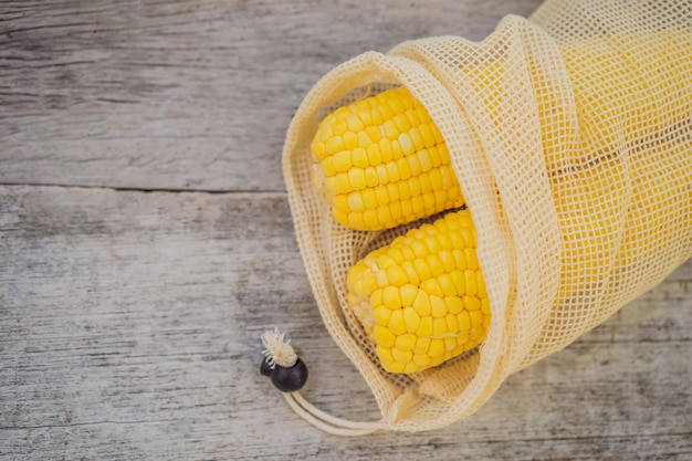 Corn in a reusable bag on a stylish wooden kitchen surface Zero waste concept