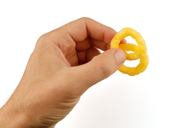 Corn rings Yellow snacks in hand isolate