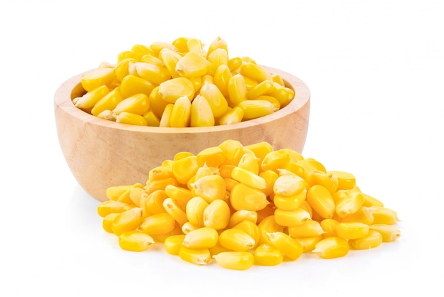 Corn seeds in wood bowl isolated on the white