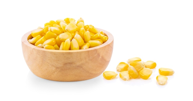 Corn seeds in wood bowl isolated on the white 