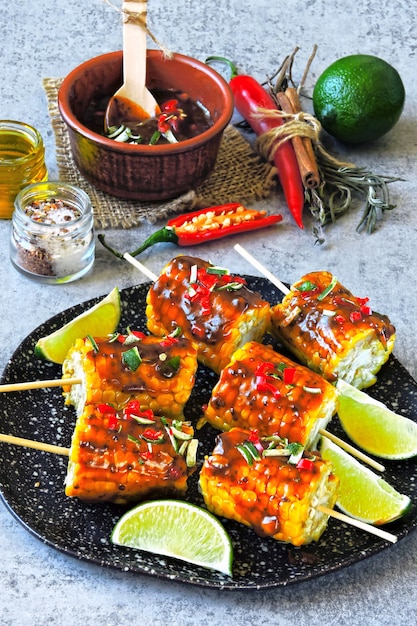 Corn on sticks with chili lime sauce.