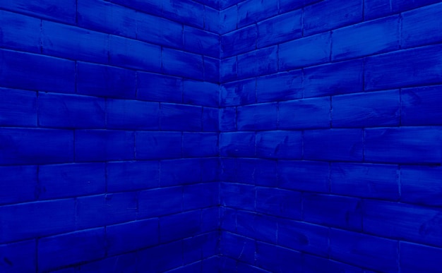 Corner of a brick wall with bricks converging in dark blue color