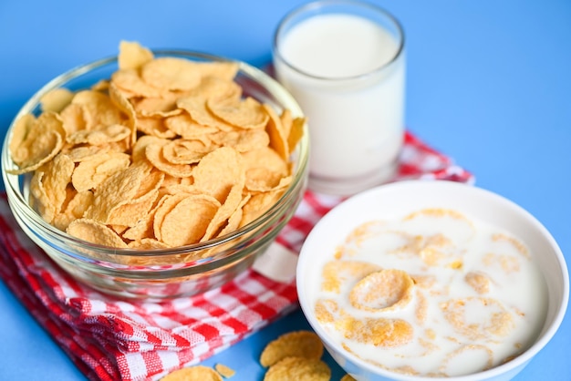 cornflakes bowl breakfast food and snack for healthy food concept, morning breakfast fresh whole grain cereal, cornflakes with milk on blue background