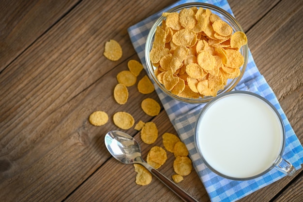 Cornflakes bowl breakfast food and snack for healthy food concept morning breakfast fresh whole grain cereal cornflakes with milk on wooden background