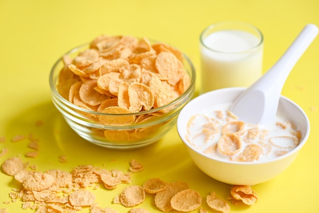 Cornflakes bowl breakfast food and snack for healthy food concept morning breakfast fresh whole grain cereal cornflakes with milk on yellow background