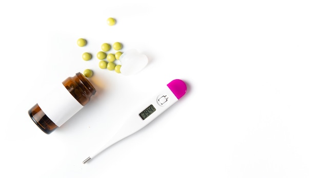 Coronavirus 2019-nCoV outbreak. Pills and drug, care during illness. Thermometer on a white isolated background.