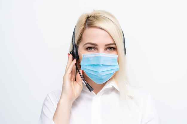 Coronavirus or Covid-19 concept. Business woman working from home wearing protective mask. Business woman in quarantine for coronavirus wearing protective mask. Working from home.