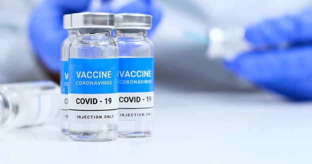 Coronavirus covid experimental vaccine vials on a white plate