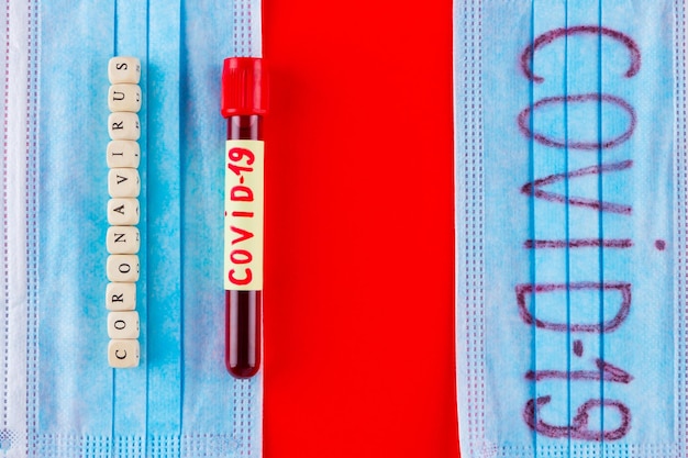 Coronavirus COVID19 Test tube with blood identified by the COVID19 coronavirus on red background