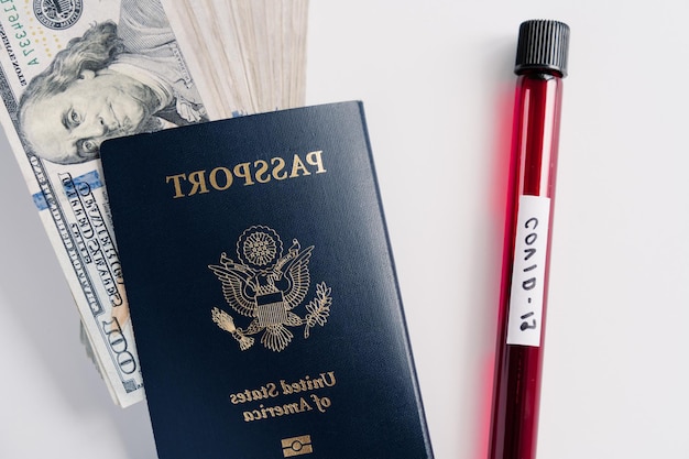 Coronavirus and travel concept Blood samples passport and money isolated on white background Canceled flights because of world pandemic Virus outbreak