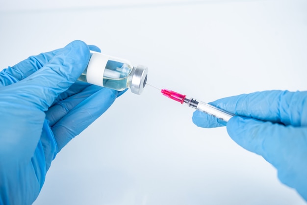 Coronavirus vaccine in bottles with syringe for injection.