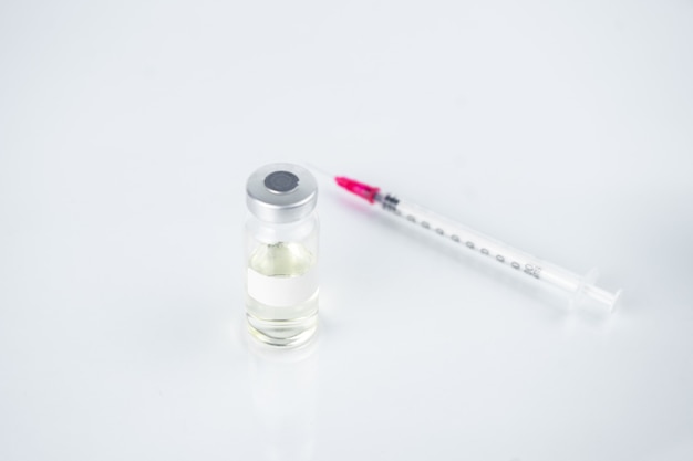 Coronavirus vaccine in bottles with syringe for injection.