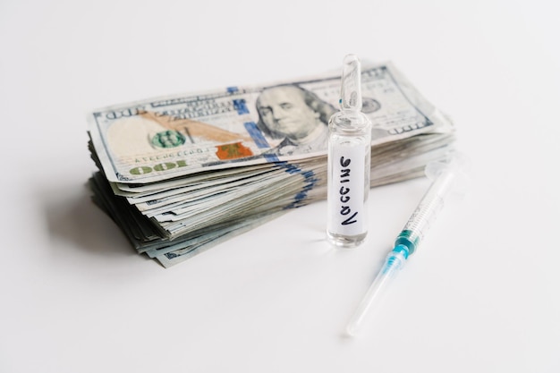 Coronavirus vaccine cost Injection syringe vaccine and money on white background Fight against Covid19 Pevention immunization and treatment concept