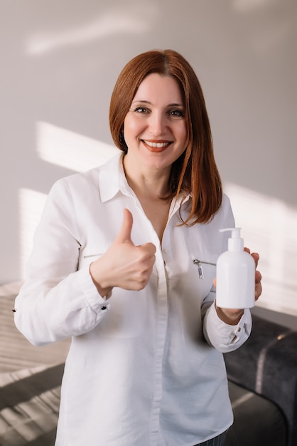 Coronavirus. Woman holding antibacterial soap sanitizer.