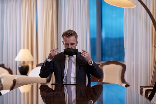 corporate business man wearing protective medical face mask at luxury office