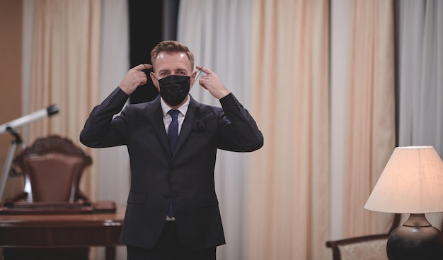 corporate business man wearing protective medical face mask at luxury office