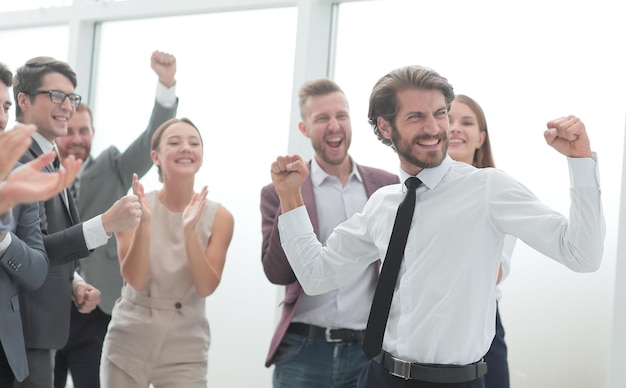 Corporate group of employees congratulating each other on the victory