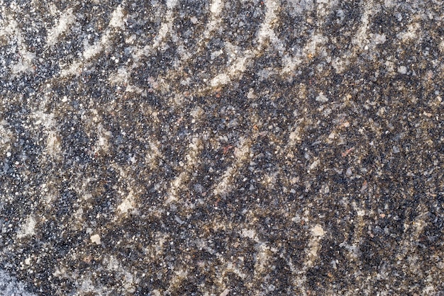 Corrugated trace of the autotire in the winter on asphalt with ice for the textured background