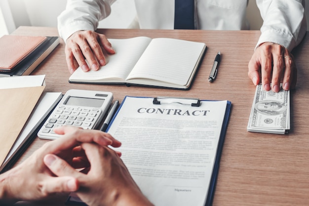 Corruption and Bribery, Businessman giving dollar bills corruption bribery to business manager to deal contract