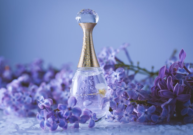 Cosmetic bottle close up with lilac flowers