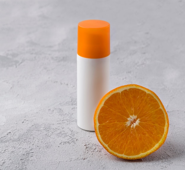 Photo cosmetic bottle container with orange.